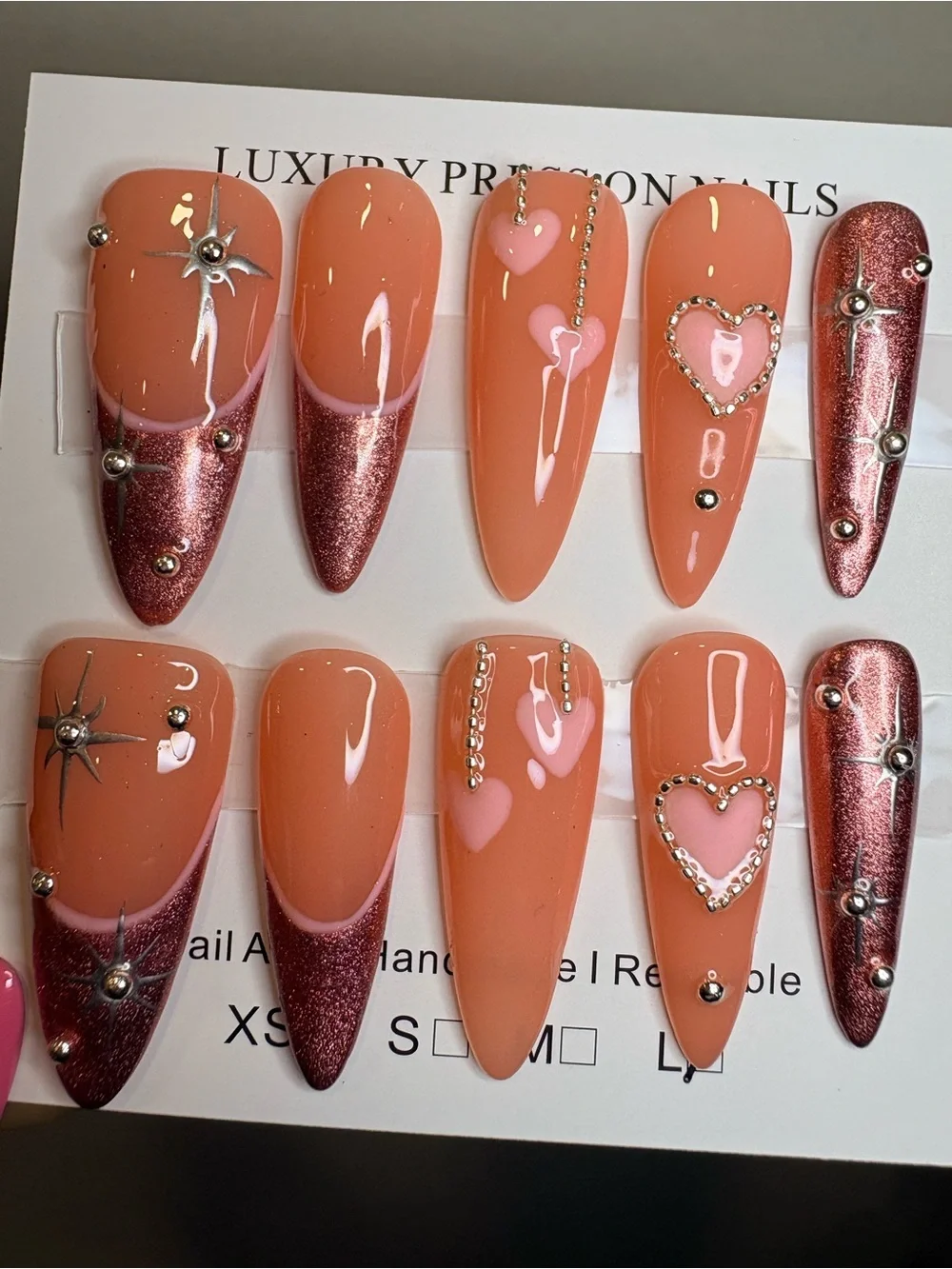 Peach Glam Stiletto Press-On Nails with Pink Hearts & Rose Metallic Tips